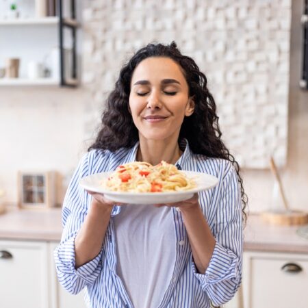 Happy,Lady,Tasting,Homemade,Spaghetti,While,Having,Lunch,,Enjoying,The